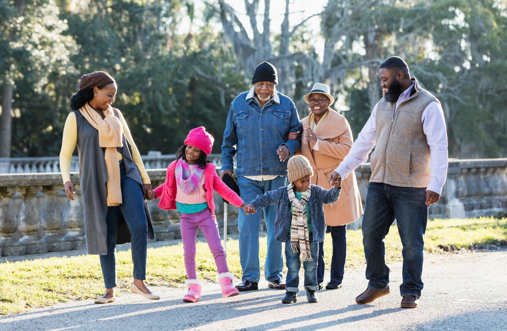 Welcoming African American family walking together outdoors