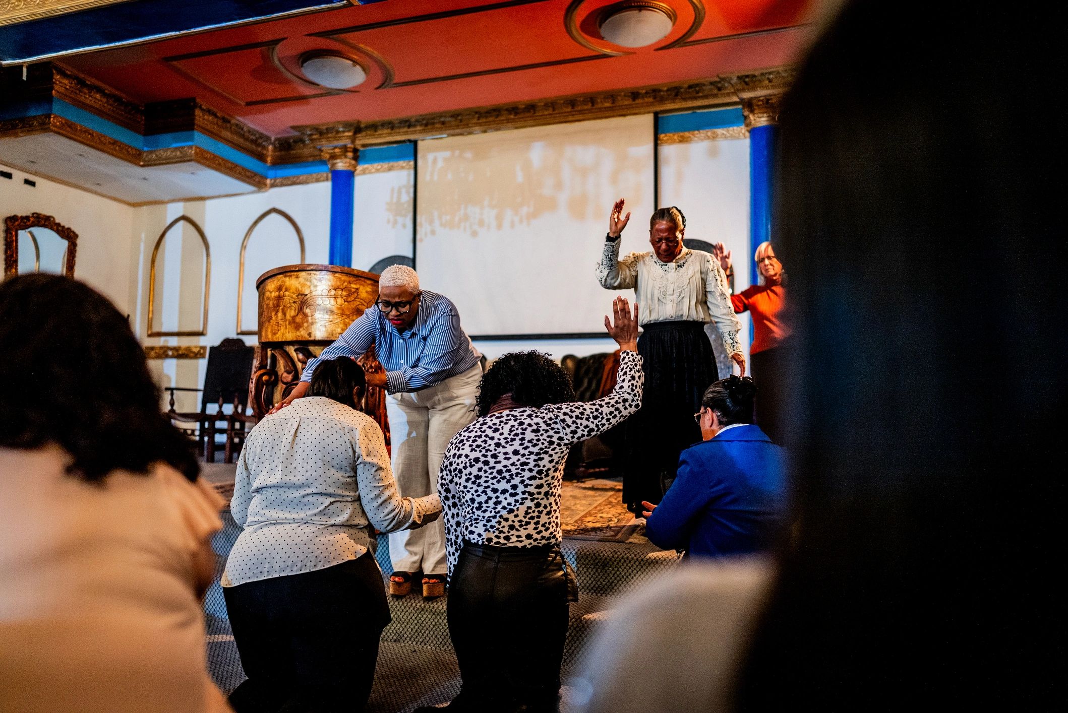 Pastor leading prayer during service
